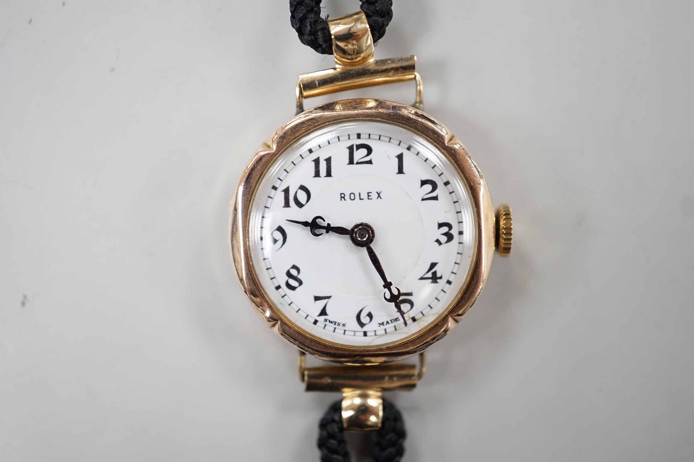 A lady's 1920's 9ct gold Rolex manual wind wrist watch, on associated fabric strap.